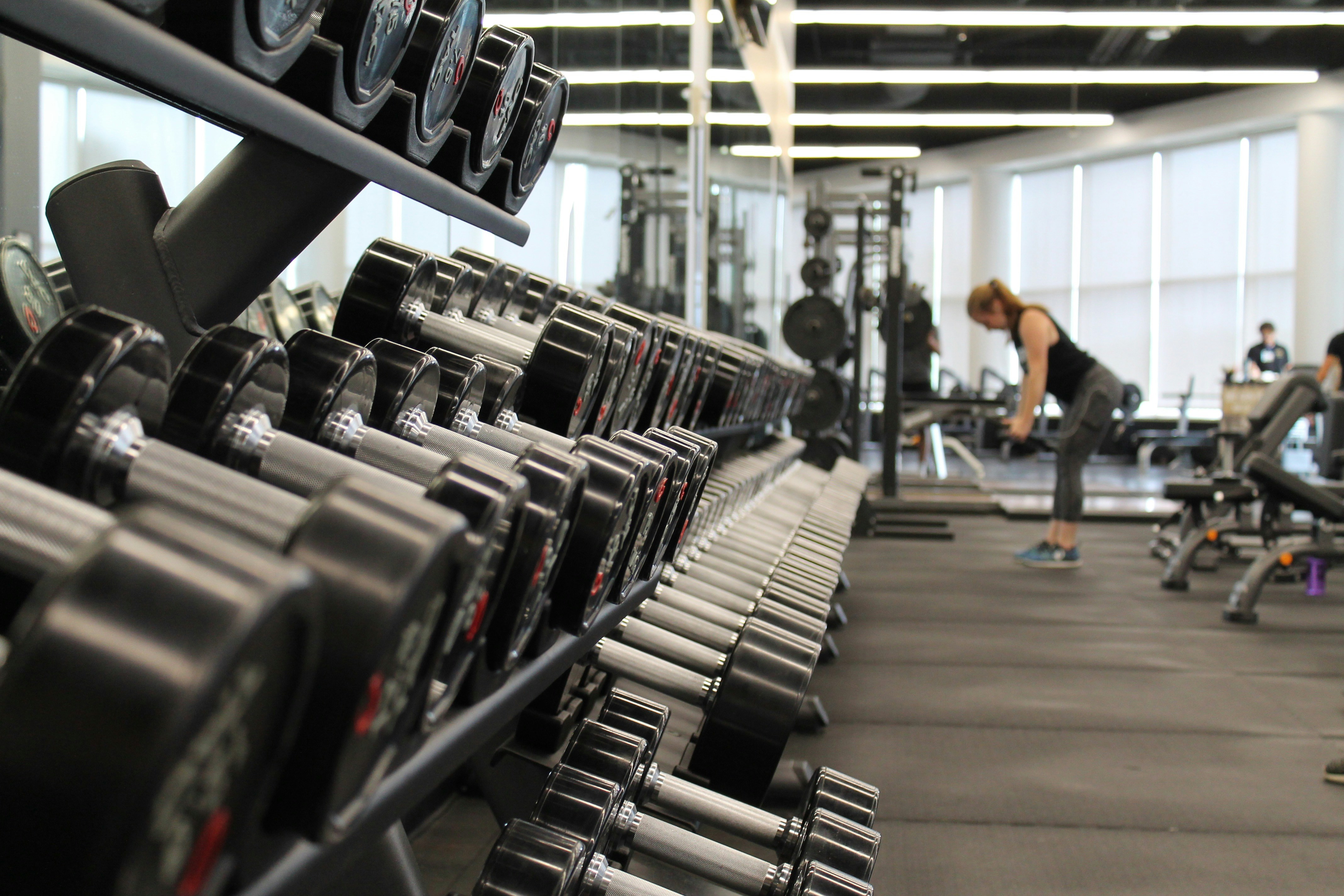Modern gym facility with an organized dumbbell rack